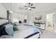 Inviting main bedroom with tray ceilings, comfortable bed, and carpet flooring with ensuite bathroom entrance at 3225 Alhambra Cir, Hampton, GA 30228