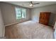 Bedroom with carpeted flooring, large window and closet at 581 N Fairfield Dr, Peachtree City, GA 30269