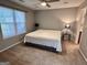 Cozy bedroom with neutral walls, plush carpeting, and natural light from the window at 581 N Fairfield Dr, Peachtree City, GA 30269