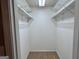 Walk-in closet featuring white shelving for organized storage and carpeted flooring at 581 N Fairfield Dr, Peachtree City, GA 30269