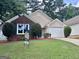 Charming single-Gathering home featuring a brick and stucco exterior with a well-manicured lawn and a two-car garage at 581 N Fairfield Dr, Peachtree City, GA 30269