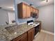Well-equipped kitchen with granite countertops, wood cabinets, and a stainless steel microwave and oven at 581 N Fairfield Dr, Peachtree City, GA 30269