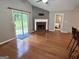 Spacious living room featuring hardwood floors, a fireplace, and sliding glass doors to a backyard space at 581 N Fairfield Dr, Peachtree City, GA 30269