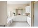 Bright bathroom features a soaking tub, dual sinks, white cabinets with gold hardware, and tile flooring at 450 Riverwalk, Mcdonough, GA 30252