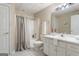 Bathroom featuring a shower, vanity, and a toilet, accented by soft, natural lighting at 450 Riverwalk, Mcdonough, GA 30252