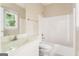 White bathroom with a combination shower and tub, a toilet, and a vanity with a mirror at 450 Riverwalk, Mcdonough, GA 30252
