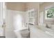 White bathroom with a combination shower and tub, a toilet, and a vanity with a mirror at 450 Riverwalk, Mcdonough, GA 30252