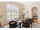 Bright dining room with large arched windows, chandelier, and hardwood floors at 450 Riverwalk, Mcdonough, GA 30252