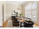 Formal dining room featuring large windows, chandelier, and seating for eight guests at 450 Riverwalk, Mcdonough, GA 30252