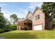Back of the house with brick exterior, a wooden deck, and a two-car garage at 450 Riverwalk, Mcdonough, GA 30252