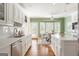 Spacious kitchen features white cabinets, stainless appliances, hardwood flooring, and an eat-in breakfast area at 450 Riverwalk, Mcdonough, GA 30252