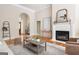 Inviting living room with fireplace, hardwood floors, and natural light at 450 Riverwalk, Mcdonough, GA 30252