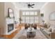 Spacious living room boasts a fireplace, hardwood floors, and tons of natural light at 450 Riverwalk, Mcdonough, GA 30252