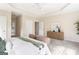 Spacious primary bedroom features neutral colors, an area rug, tray ceilings, and plenty of natural light at 450 Riverwalk, Mcdonough, GA 30252