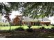 Lush backyard featuring a sprawling lawn, mature trees, and a well-maintained garden, offering a tranquil outdoor space at 405 Mallory Cir, Loganville, GA 30052