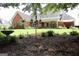 Picturesque backyard with an expansive lawn, mature trees, and a charming garden, creating a peaceful retreat at 405 Mallory Cir, Loganville, GA 30052