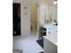 A bright bathroom connects to a closet and features a vanity area, toilet, and shower at 405 Mallory Cir, Loganville, GA 30052