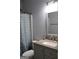 Renovated bathroom featuring vanity, sink, toilet and shower with patterned curtain at 405 Mallory Cir, Loganville, GA 30052