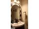 A charming bathroom features an ornate mirror, vessel sink, and bronze fixtures at 405 Mallory Cir, Loganville, GA 30052