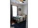 Bedroom featuring ceiling fan, window with curtains and view of the bed with blankets at 405 Mallory Cir, Loganville, GA 30052