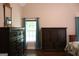 A spacious bedroom is furnished with a large dark wood dresser and has ample natural light at 405 Mallory Cir, Loganville, GA 30052