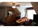 Cozy upstairs bonus room with a ceiling fan, large dresser, comfortable sofa and decor at 405 Mallory Cir, Loganville, GA 30052