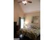 A cozy bedroom with vaulted ceilings features a floral bedspread and bright natural light at 405 Mallory Cir, Loganville, GA 30052