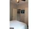 Well-lit bedroom with a white patterned comforter, gray walls, and an open doorway at 405 Mallory Cir, Loganville, GA 30052