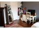 Bright bedroom features a wooden floor, gray walls, desk with a desktop computer, and leaning mirror at 405 Mallory Cir, Loganville, GA 30052