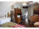 A bedroom with wood floors, a large mirror, computer desk and closet door at 405 Mallory Cir, Loganville, GA 30052