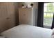 Charming bedroom features a bed with white patterned bedding, wardrobe and a window with natural light at 405 Mallory Cir, Loganville, GA 30052