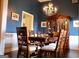 Traditional dining room with dark blue walls, and wood furniture at 405 Mallory Cir, Loganville, GA 30052