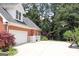 Well-maintained exterior with brick siding, white trim, and a spacious driveway featuring a basketball hoop at 405 Mallory Cir, Loganville, GA 30052