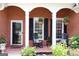 Welcoming front porch with rocking chairs and decorative hanging plants at 405 Mallory Cir, Loganville, GA 30052