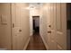 A well-lit hallway with hardwood floors connects various rooms in the home at 405 Mallory Cir, Loganville, GA 30052