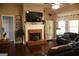 Well-lit living room with a brick fireplace and comfortable leather furniture at 405 Mallory Cir, Loganville, GA 30052