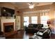 Cozy living room with a brick fireplace, a ceiling fan, and comfortable seating at 405 Mallory Cir, Loganville, GA 30052