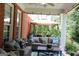 Inviting covered patio features comfortable seating, an outdoor dining area, and lush landscaping at 405 Mallory Cir, Loganville, GA 30052