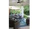 Inviting covered patio with comfortable seating, an outdoor dining area, and lush landscaping at 405 Mallory Cir, Loganville, GA 30052