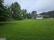Expansive backyard featuring lush green grass and a screened-in porch area at 1997 Villa Rica Hwy, Dallas, GA 30157