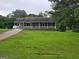 Charming single-story home with a covered porch and well-maintained front yard at 1997 Villa Rica Hwy, Dallas, GA 30157