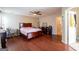 Hardwood floors accent this spacious bedroom with adjoining bathroom at 2545 Lake Royale Dr, Riverdale, GA 30296
