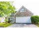 Charming home featuring a stone facade and a two-car garage, creating inviting curb appeal at 2545 Lake Royale Dr, Riverdale, GA 30296