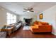 Cozy living room with a ceiling fan, natural light, and hardwood floors, making it a comfortable space at 2545 Lake Royale Dr, Riverdale, GA 30296