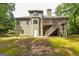 Exterior view of home with large back deck, greenery and shaded lawn at 500 Barrington Farms Pkwy, Sharpsburg, GA 30277