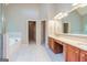 Bathroom featuring double vanities, tile floors, a garden tub, and shower at 500 Barrington Farms Pkwy, Sharpsburg, GA 30277