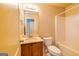 Full bathroom features a shower-tub combo, single sink vanity and warm lighting at 500 Barrington Farms Pkwy, Sharpsburg, GA 30277