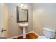 Powder room featuring pedestal sink, decorative mirror and lighting at 500 Barrington Farms Pkwy, Sharpsburg, GA 30277