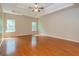 Bedroom boasts wood flooring, two windows, and a ceiling fan at 500 Barrington Farms Pkwy, Sharpsburg, GA 30277