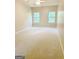 Bedroom with neutral carpet and two windows providing ample natural light at 500 Barrington Farms Pkwy, Sharpsburg, GA 30277